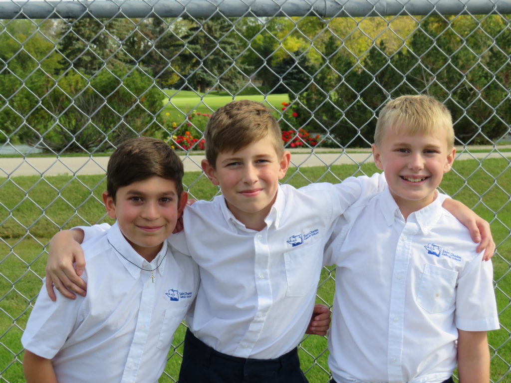 boys at schoolyard fence